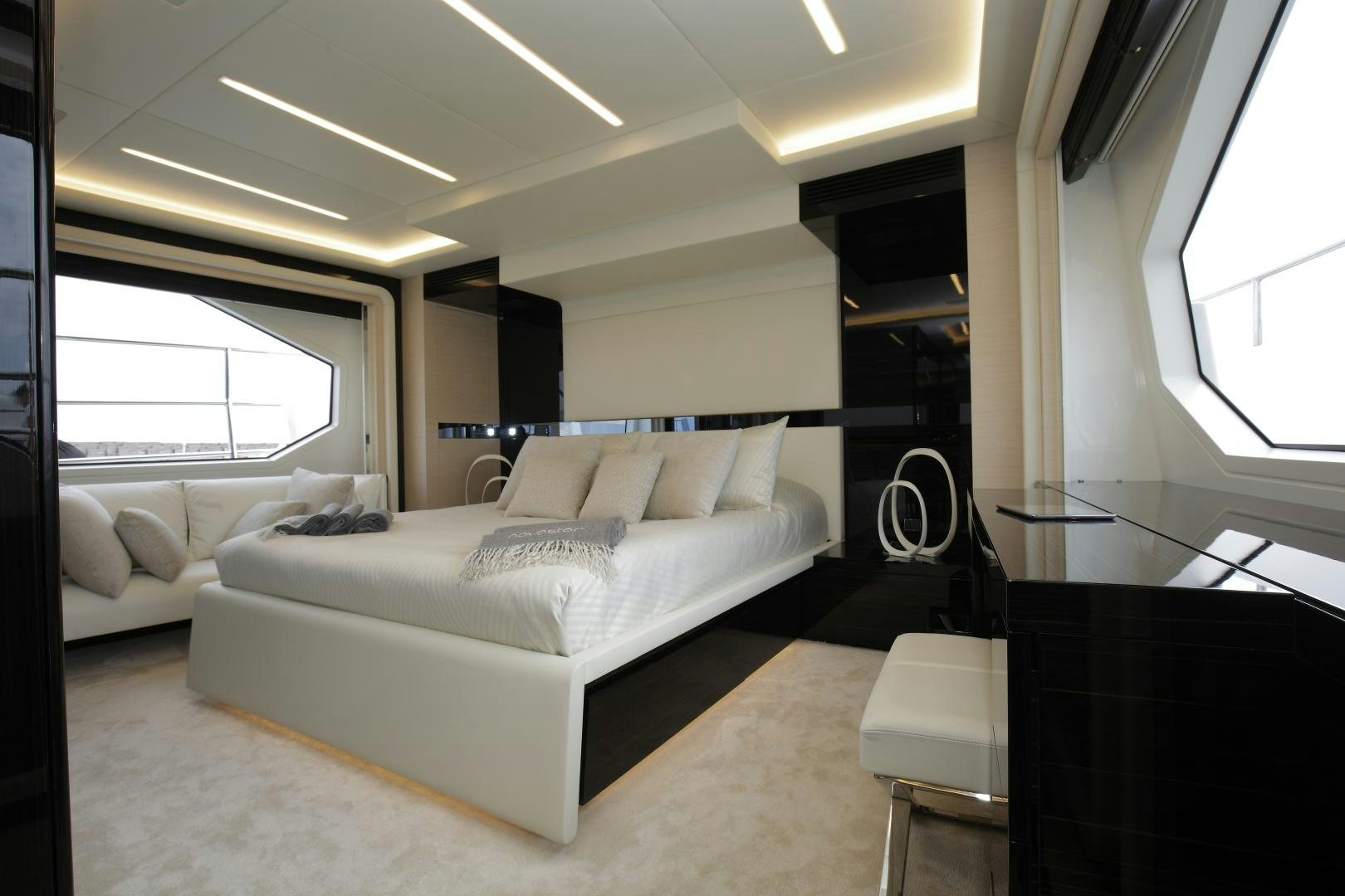 a room with a bed and a couch aboard NOVASTAR Yacht for Sale