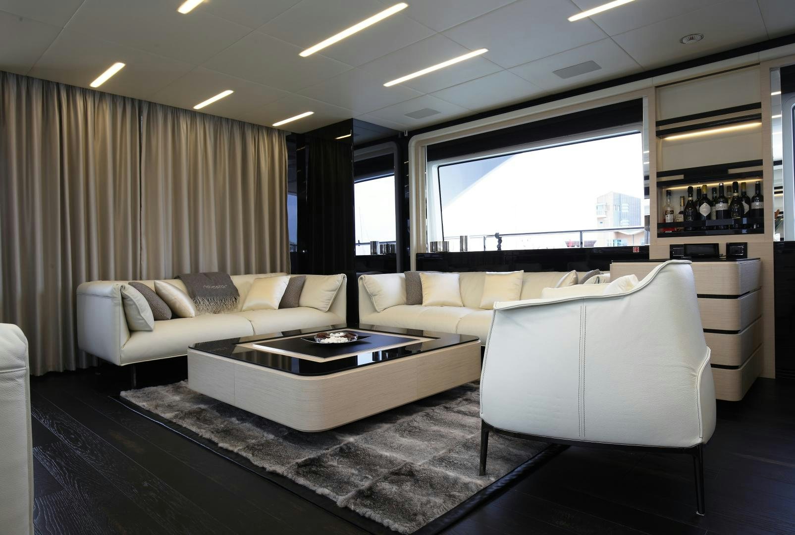 a living room with a table and couches aboard NOVASTAR Yacht for Sale
