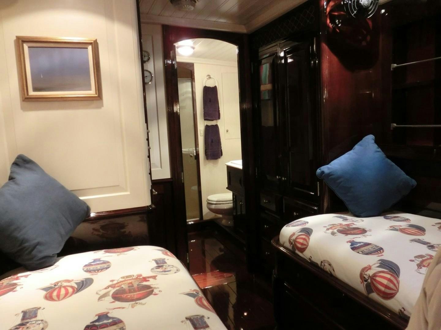 a room with a bed and a mirror aboard CARMELLA  Yacht for Sale