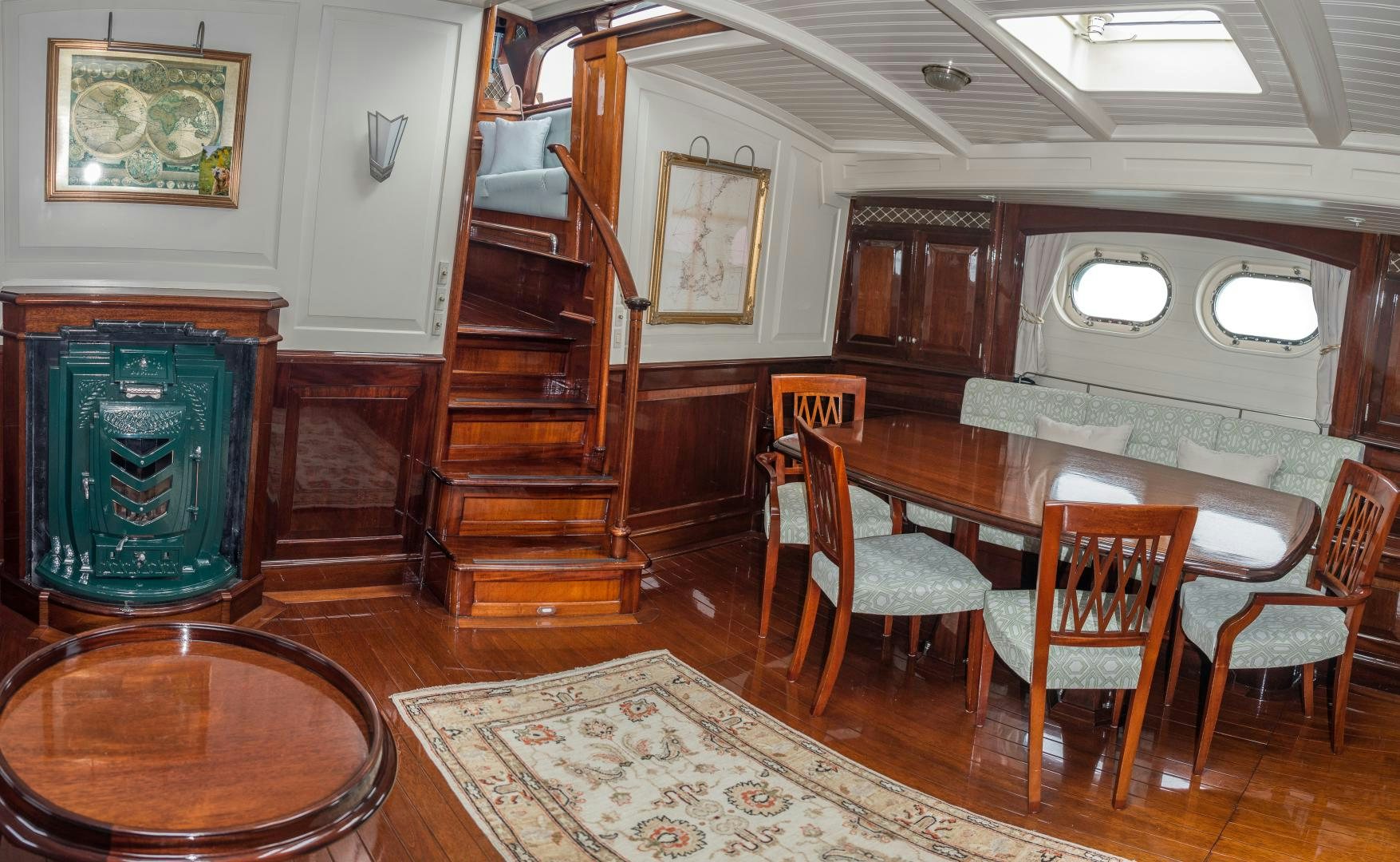a large room with a table and chairs aboard CARMELLA  Yacht for Sale