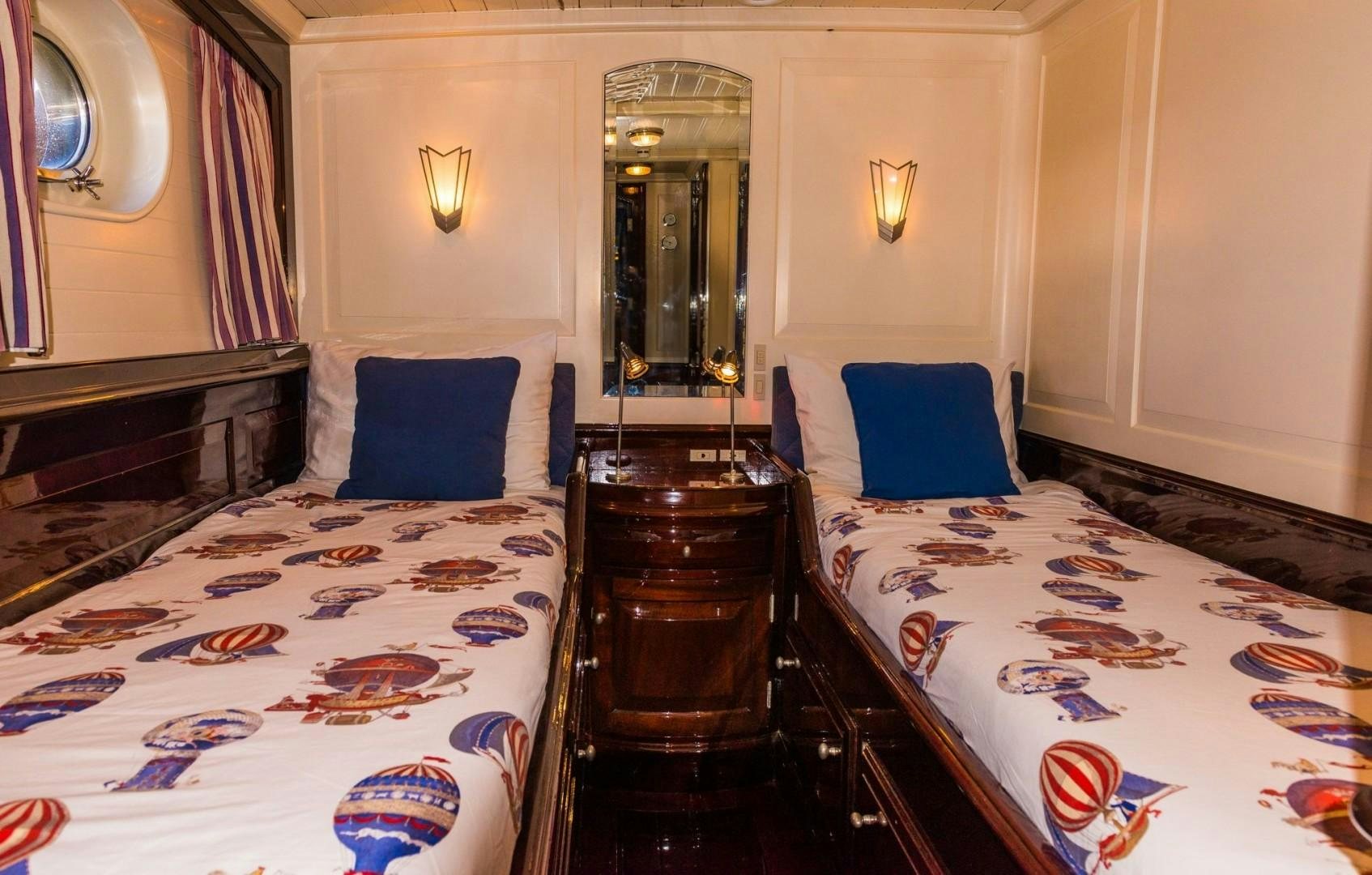 a bedroom with a bed and a mirror aboard CARMELLA  Yacht for Sale