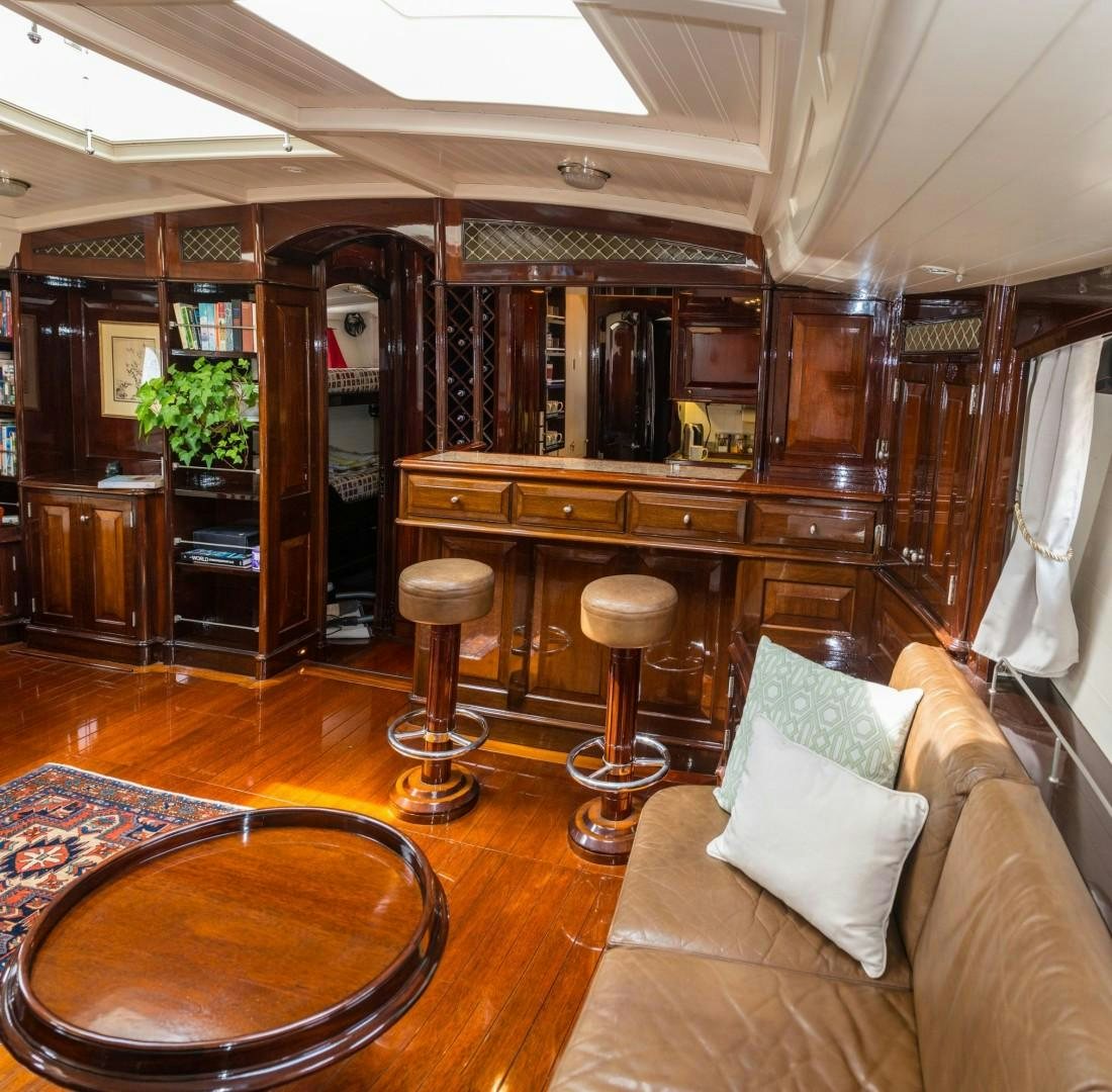 a living room with a couch and a table aboard CARMELLA  Yacht for Sale