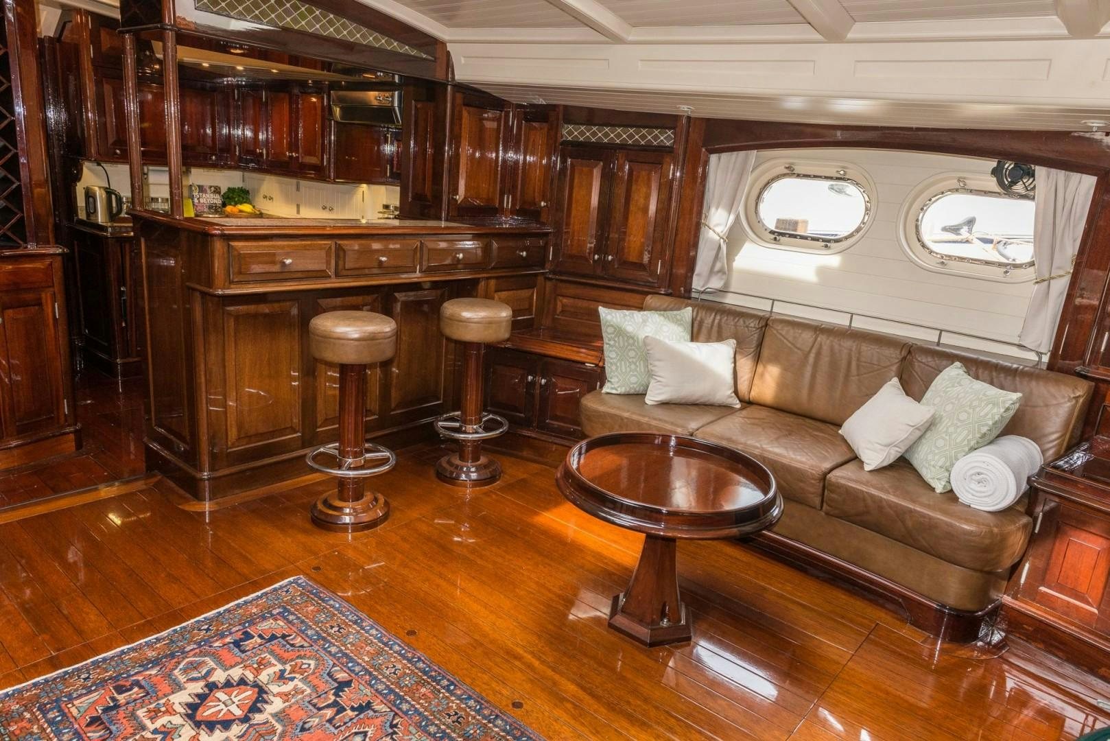 a living room with a couch and a coffee table aboard CARMELLA  Yacht for Sale