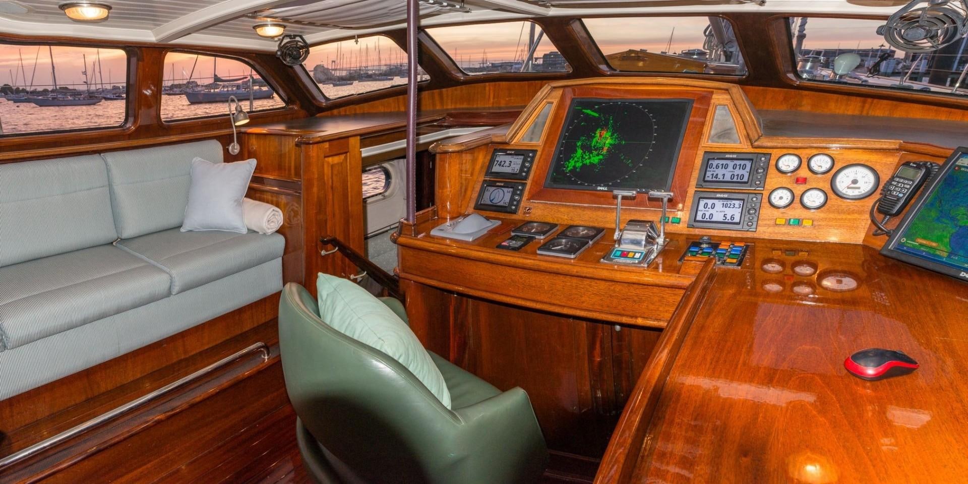 a living room with a couch and a television aboard CARMELLA  Yacht for Sale