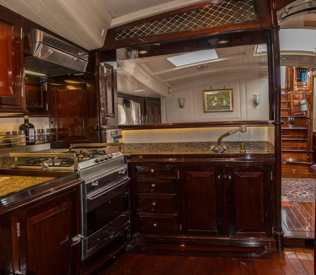 a kitchen with wooden cabinets aboard CARMELLA  Yacht for Sale
