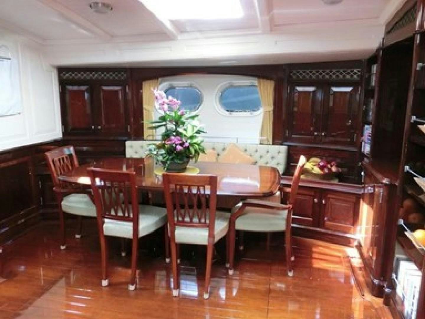 a dining room with a table and chairs aboard CARMELLA  Yacht for Sale