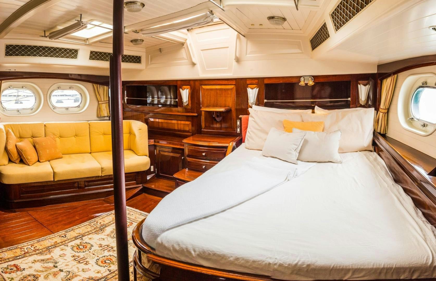 a room with a bed and a couch aboard CARMELLA  Yacht for Sale