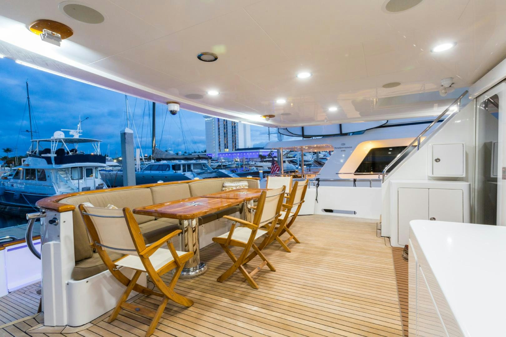 a room with tables and chairs aboard DEAL MAKER Yacht for Sale