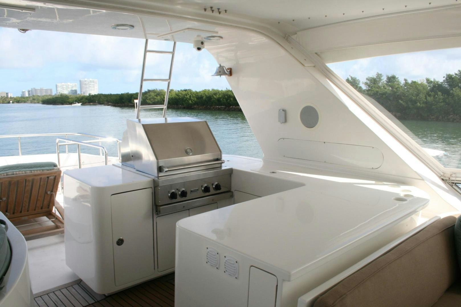 a white kitchen with a large window aboard DEAL MAKER Yacht for Sale