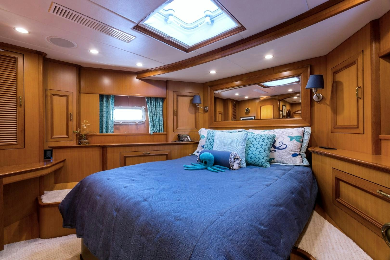a bedroom with a bed and a window aboard DEAL MAKER Yacht for Sale
