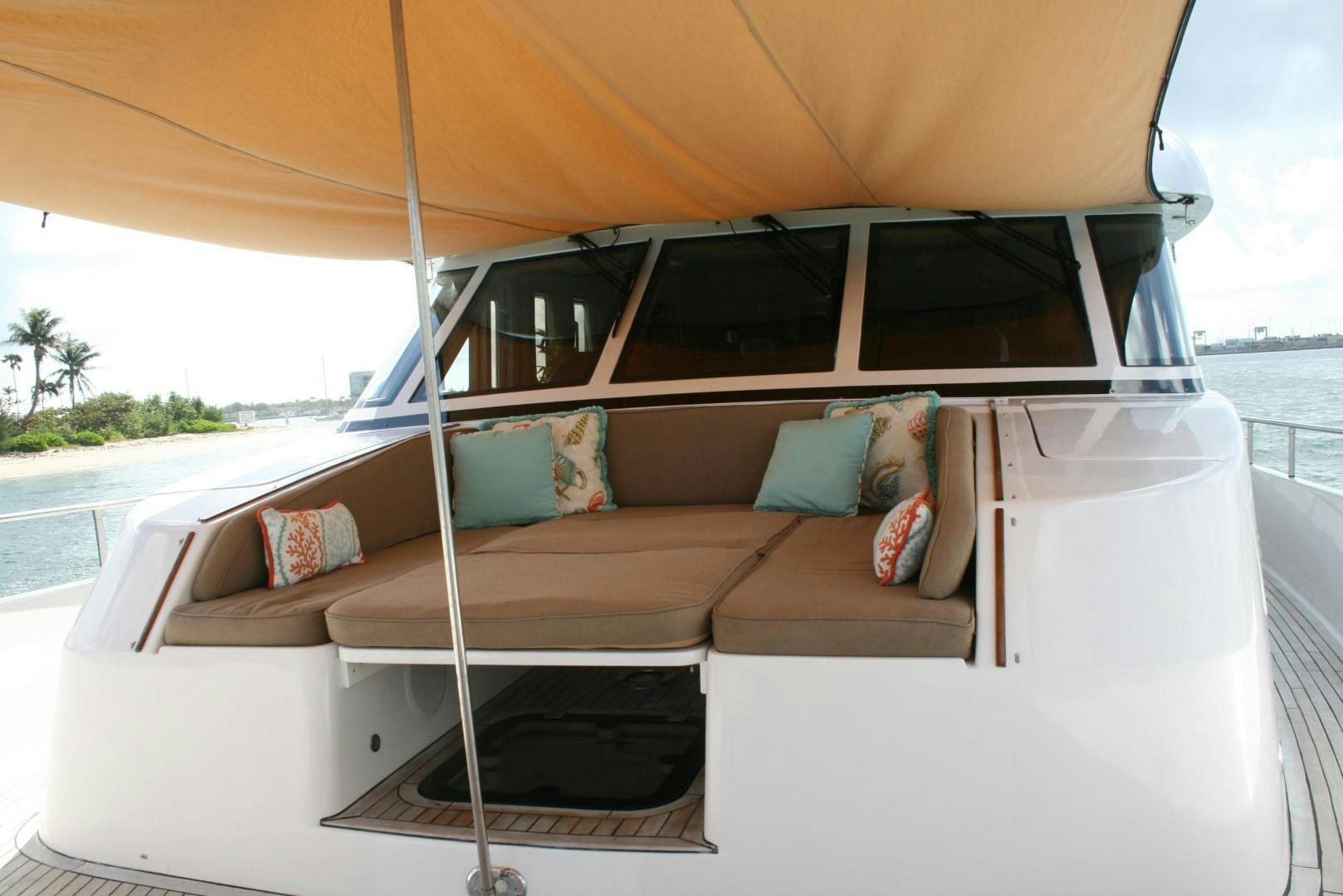 a white couch with pillows on it aboard DEAL MAKER Yacht for Sale