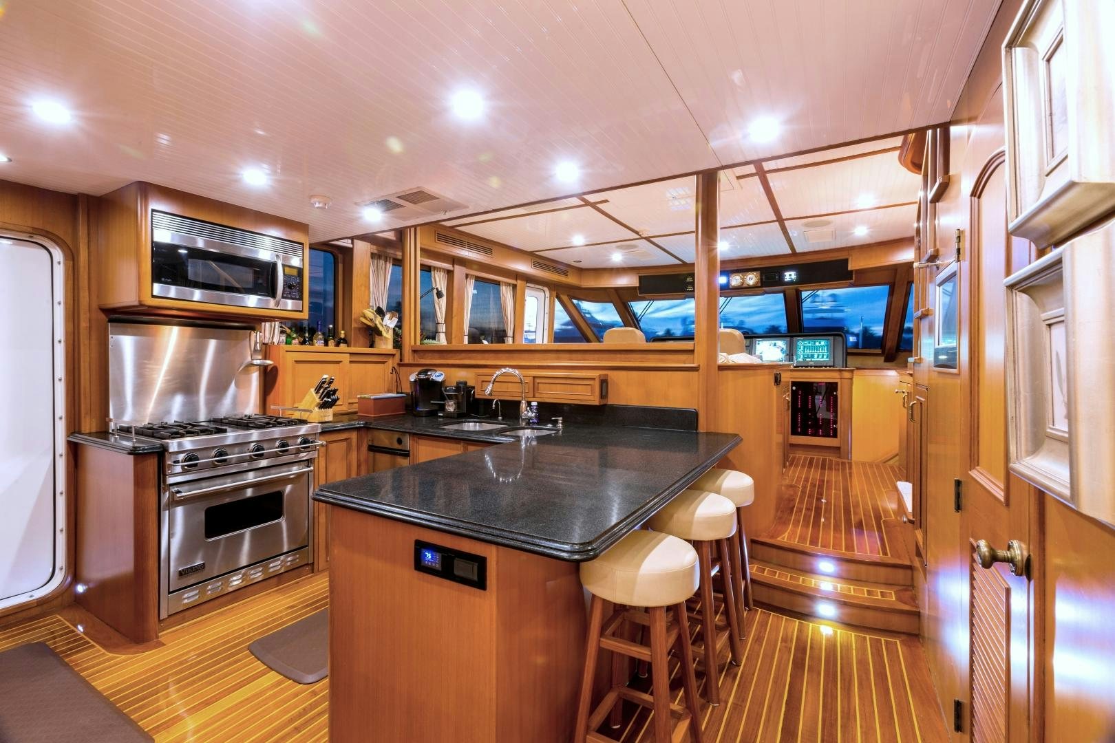 a kitchen with a large island aboard DEAL MAKER Yacht for Sale