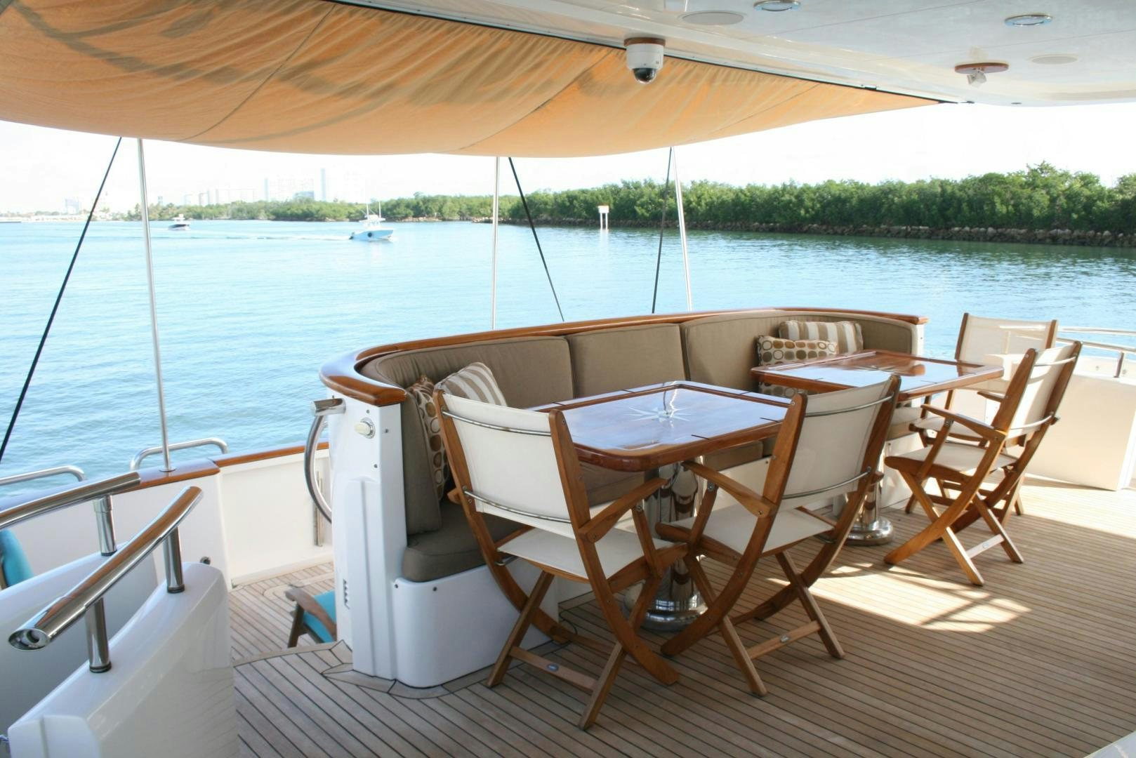 a table and chairs on a deck aboard DEAL MAKER Yacht for Sale