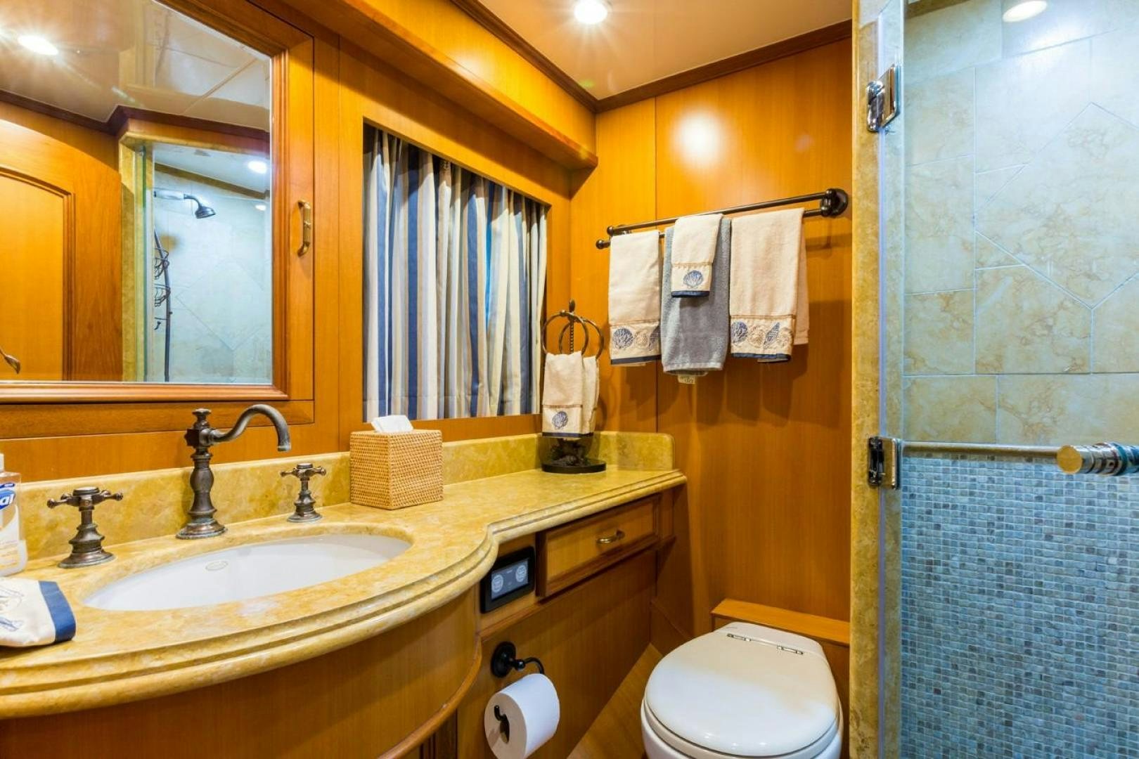 a bathroom with a sink toilet and towels aboard DEAL MAKER Yacht for Sale