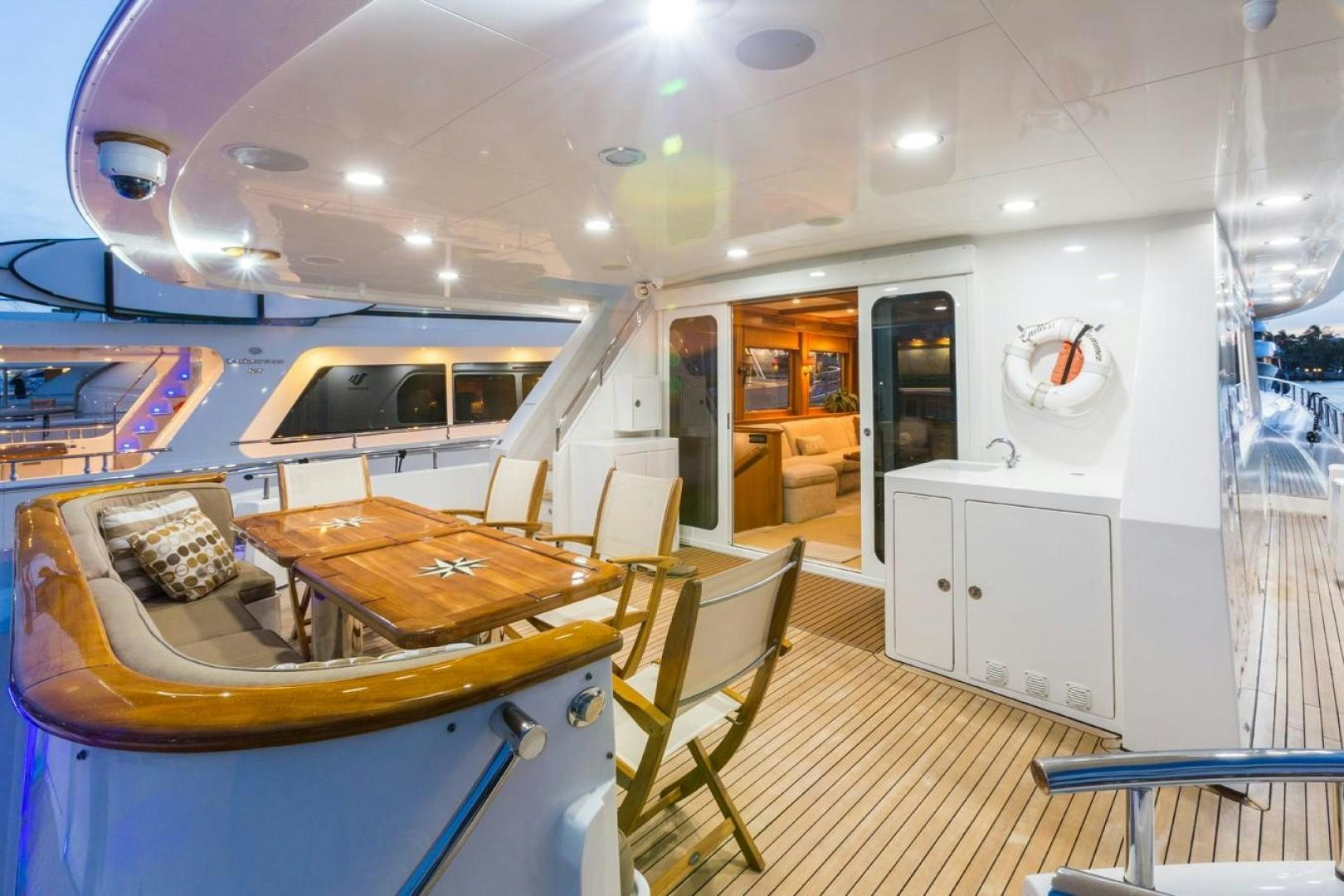a large room with a pool table and chairs aboard DEAL MAKER Yacht for Sale