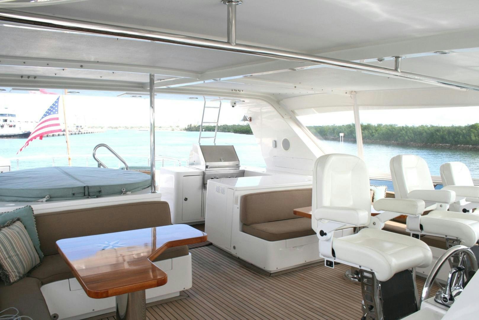 a boat with a flag on the deck aboard DEAL MAKER Yacht for Sale