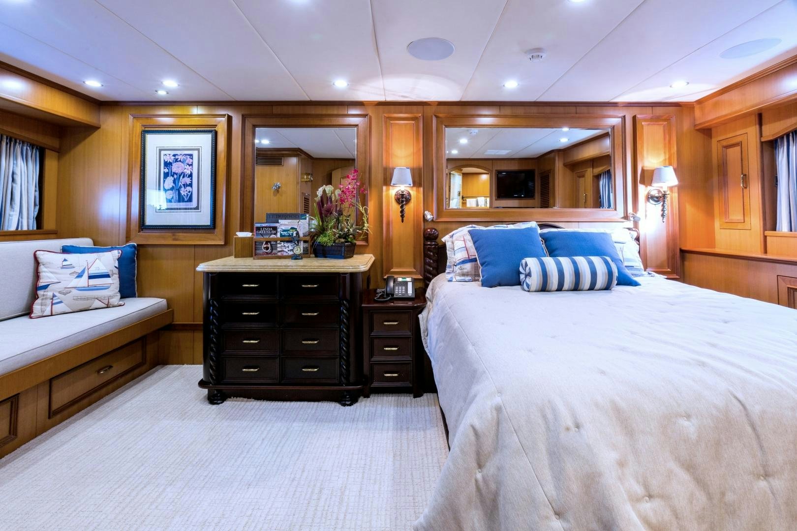 a bedroom with a bed and a dresser aboard DEAL MAKER Yacht for Sale