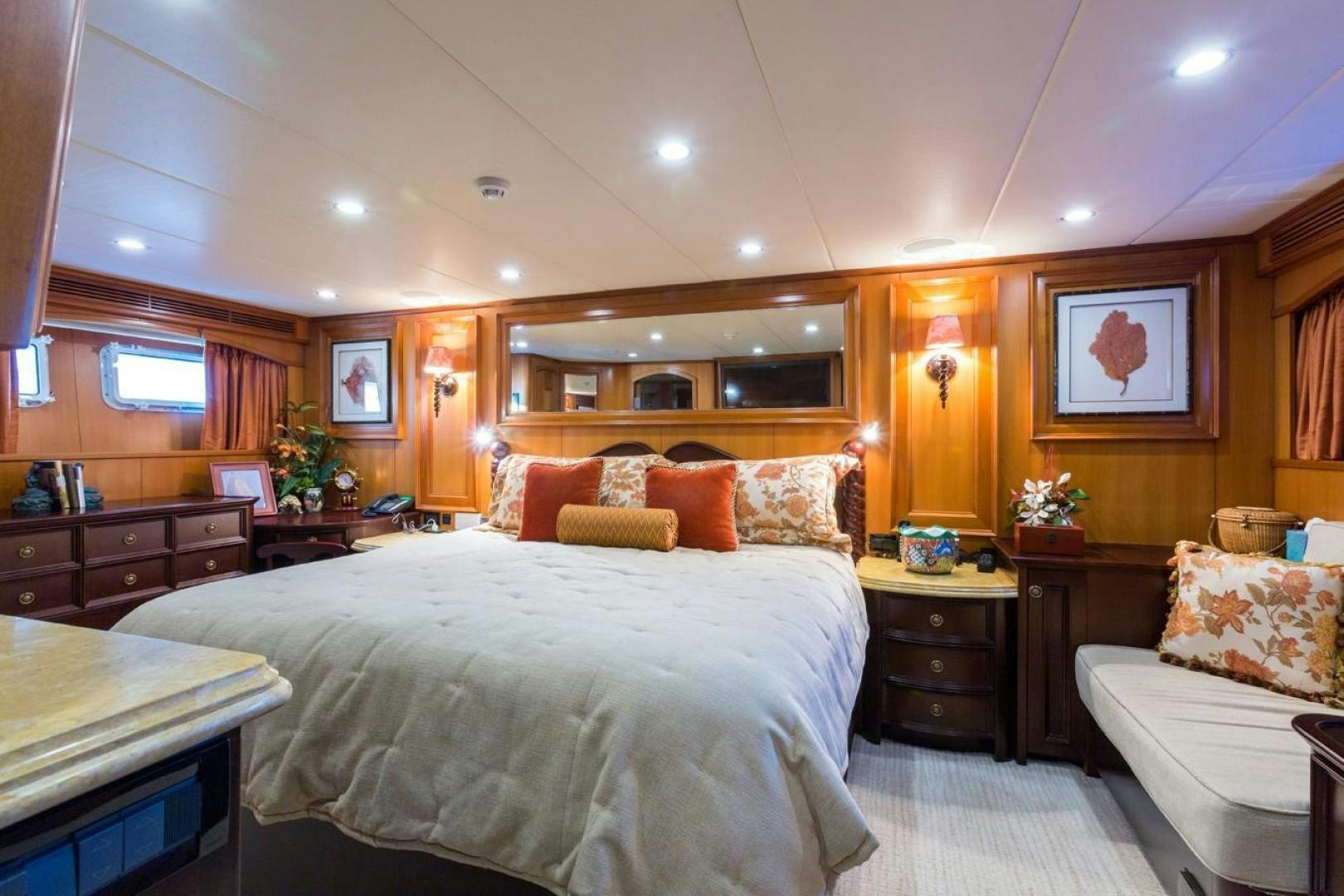 a bedroom with a bed and a desk aboard DEAL MAKER Yacht for Sale