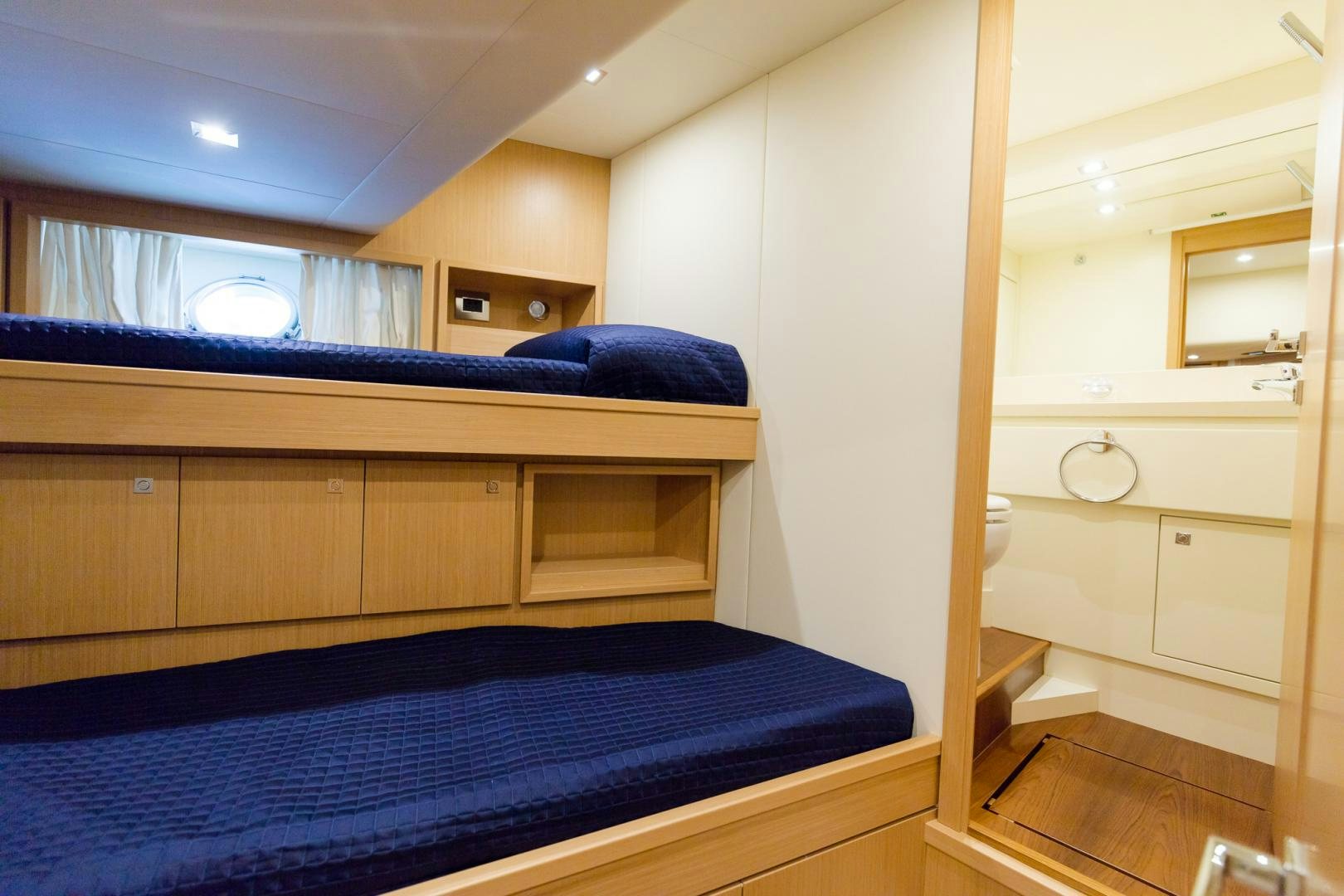 a room with a bed and a dresser aboard BONUS ROUND Yacht for Sale