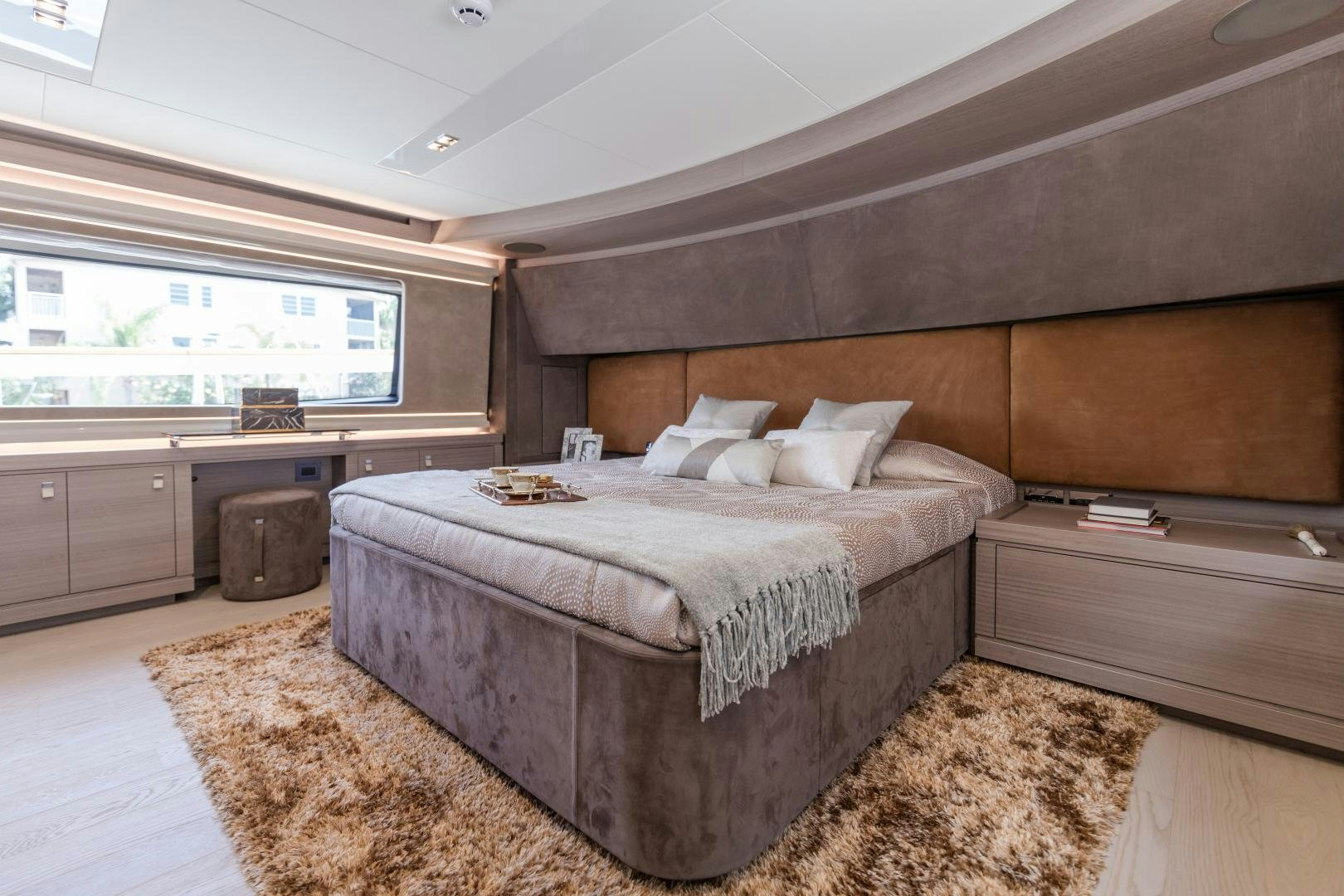 a bedroom with a bed and a desk aboard BONUS ROUND Yacht for Sale