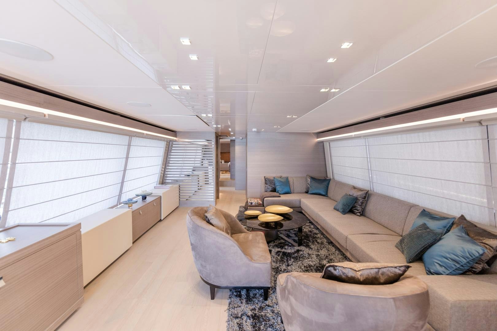 a living room with a couch and a window aboard BONUS ROUND Yacht for Sale