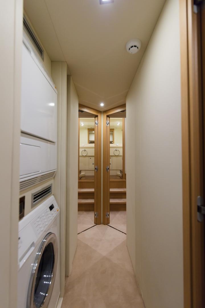 a hallway with a door and a washing machine aboard BONUS ROUND Yacht for Sale