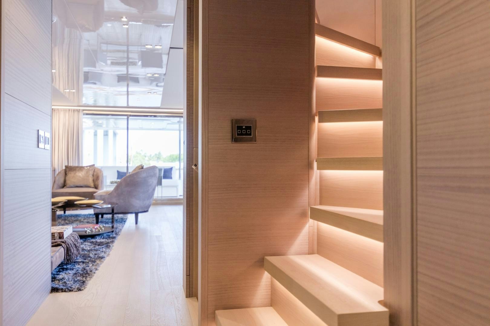 a room with a staircase and a couch aboard BONUS ROUND Yacht for Sale