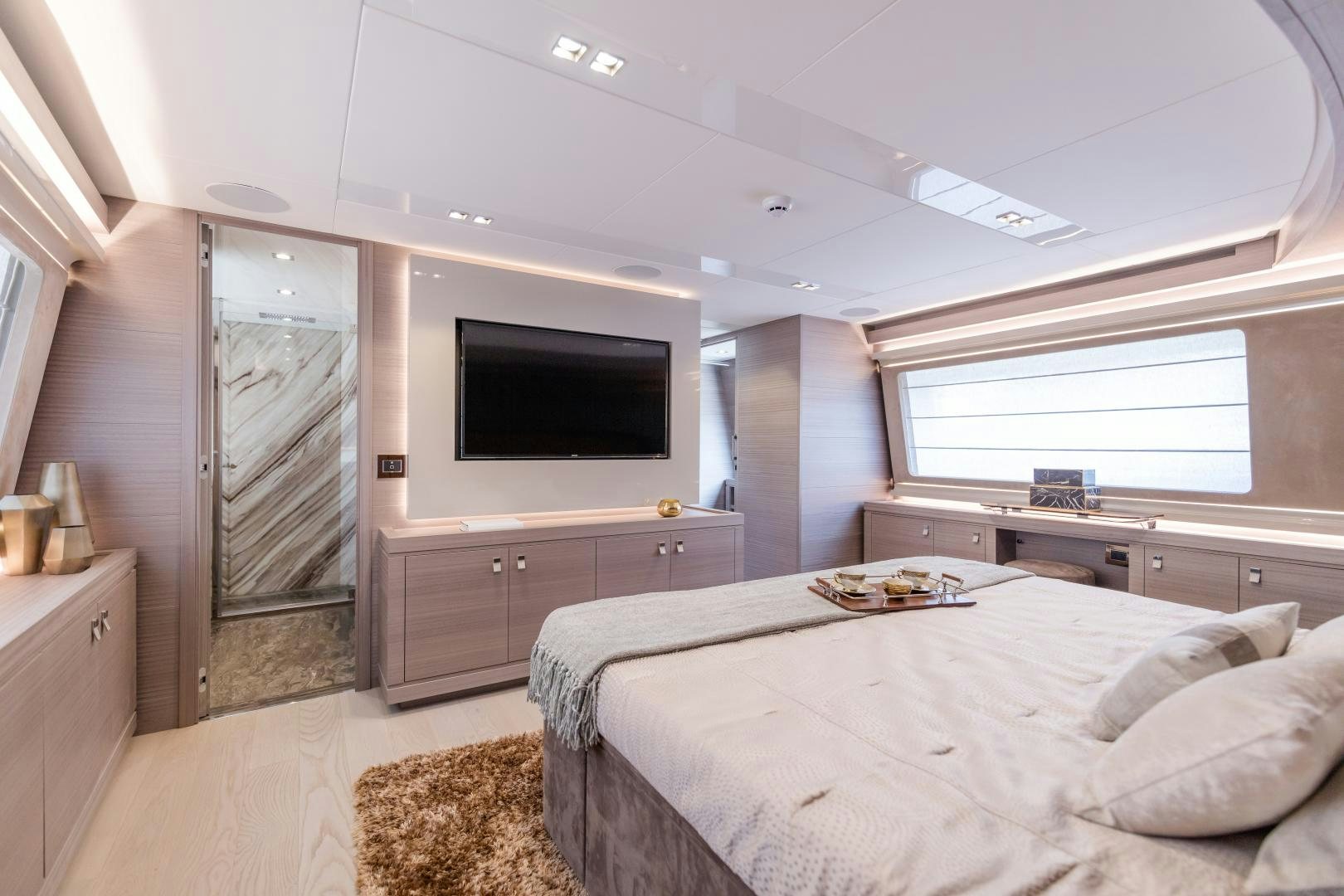 a bedroom with a bed and a tv aboard BONUS ROUND Yacht for Sale