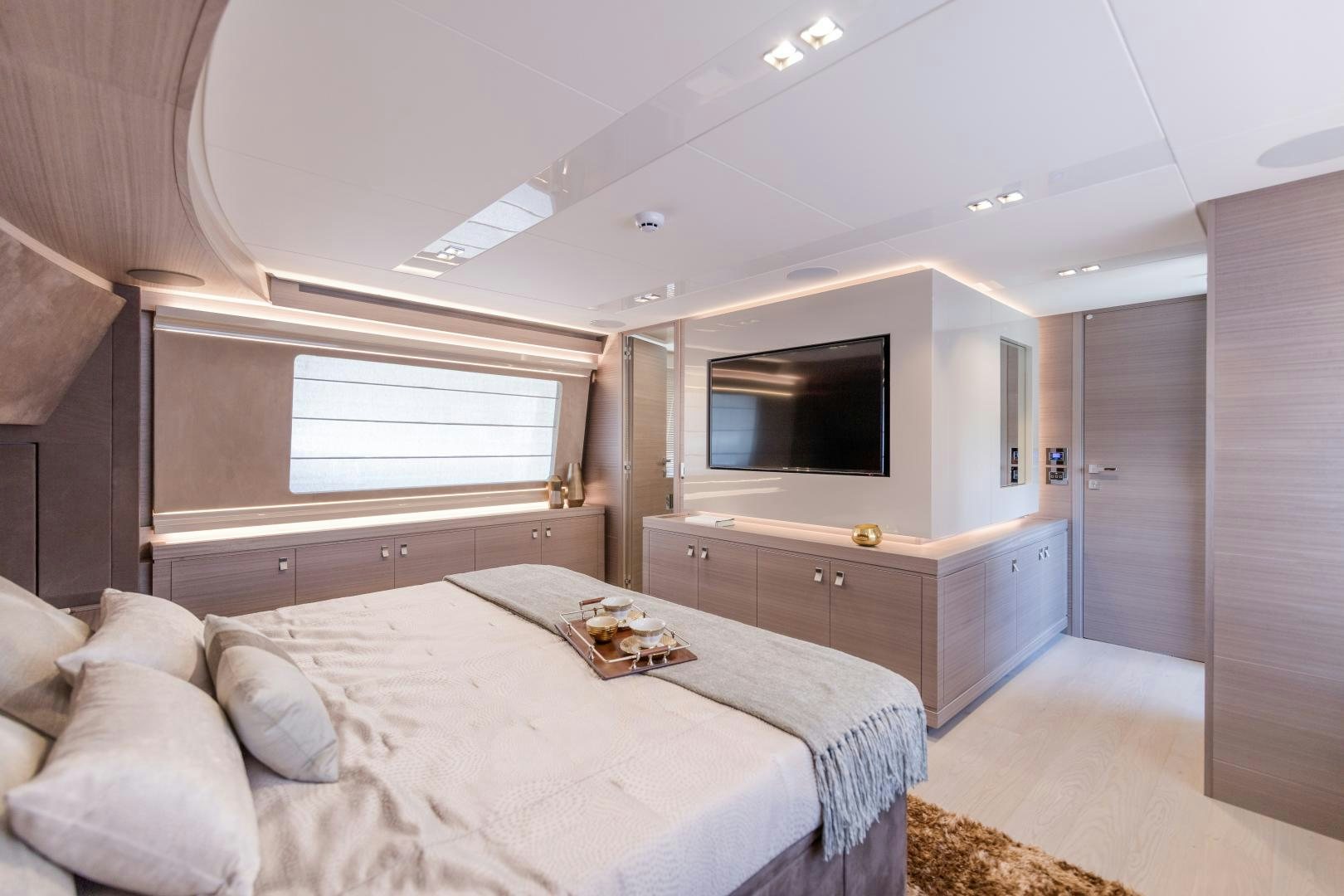 a bedroom with a bed and a tv aboard BONUS ROUND Yacht for Sale