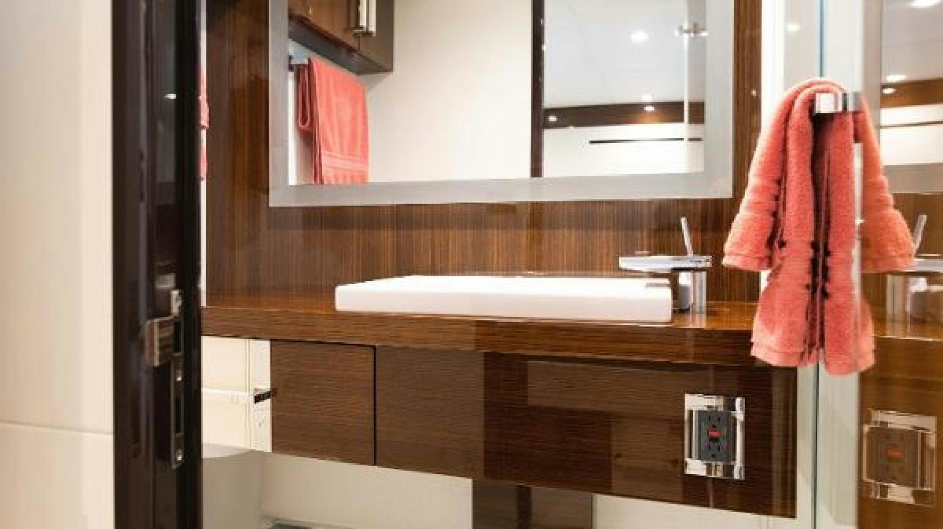 a bathroom with a sink and towels aboard Z Yacht for Sale
