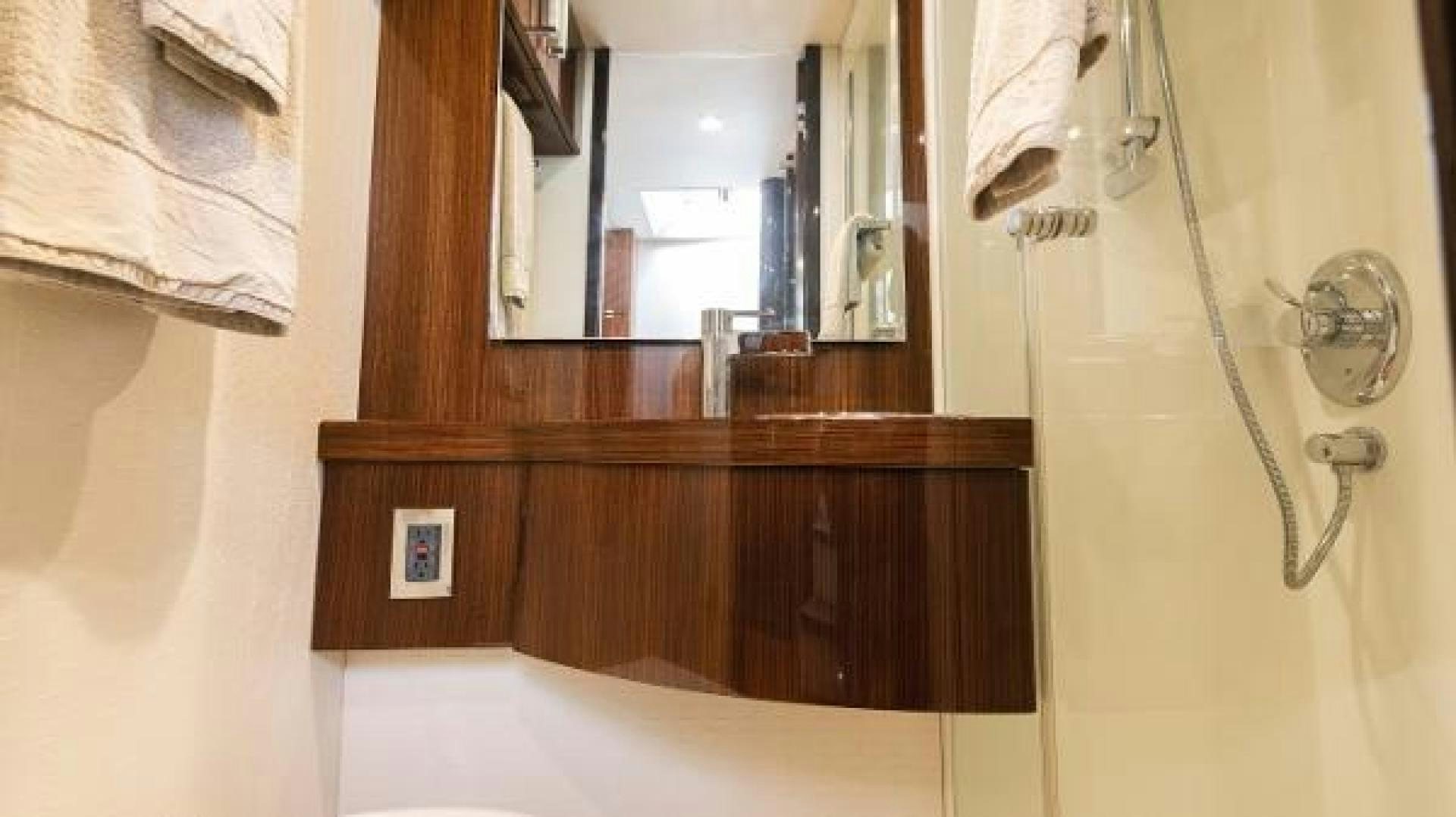 a bathroom with a mirror and a sink aboard Z Yacht for Sale