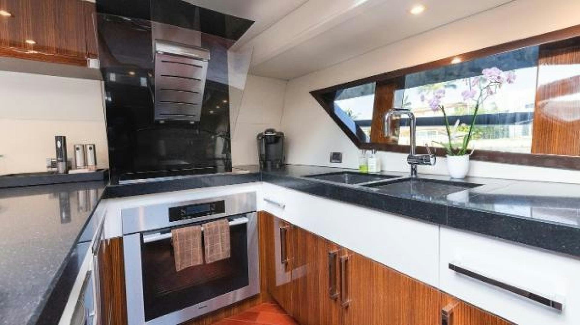 a kitchen with black and white appliances aboard Z Yacht for Sale