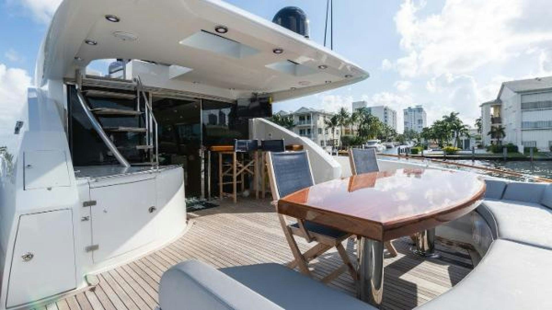 a deck with tables and chairs aboard Z Yacht for Sale