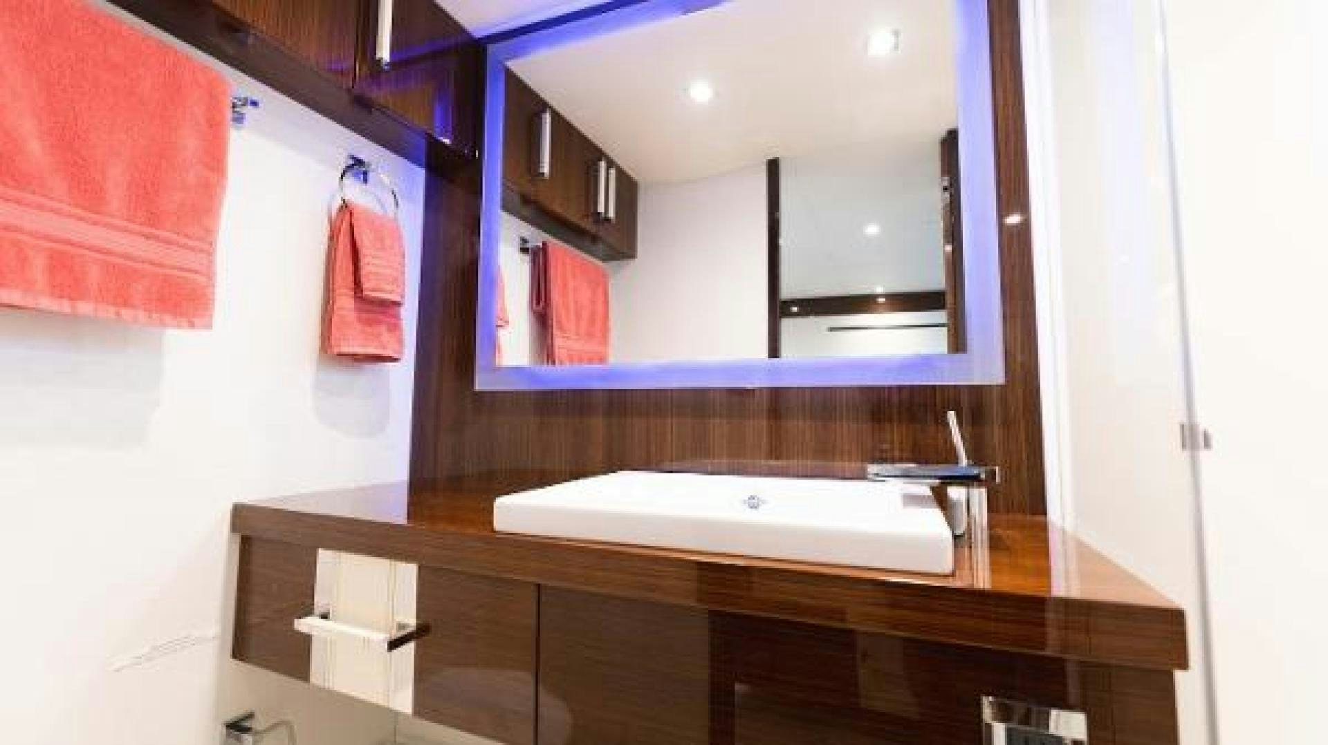 a bathroom with a large mirror aboard Z Yacht for Sale