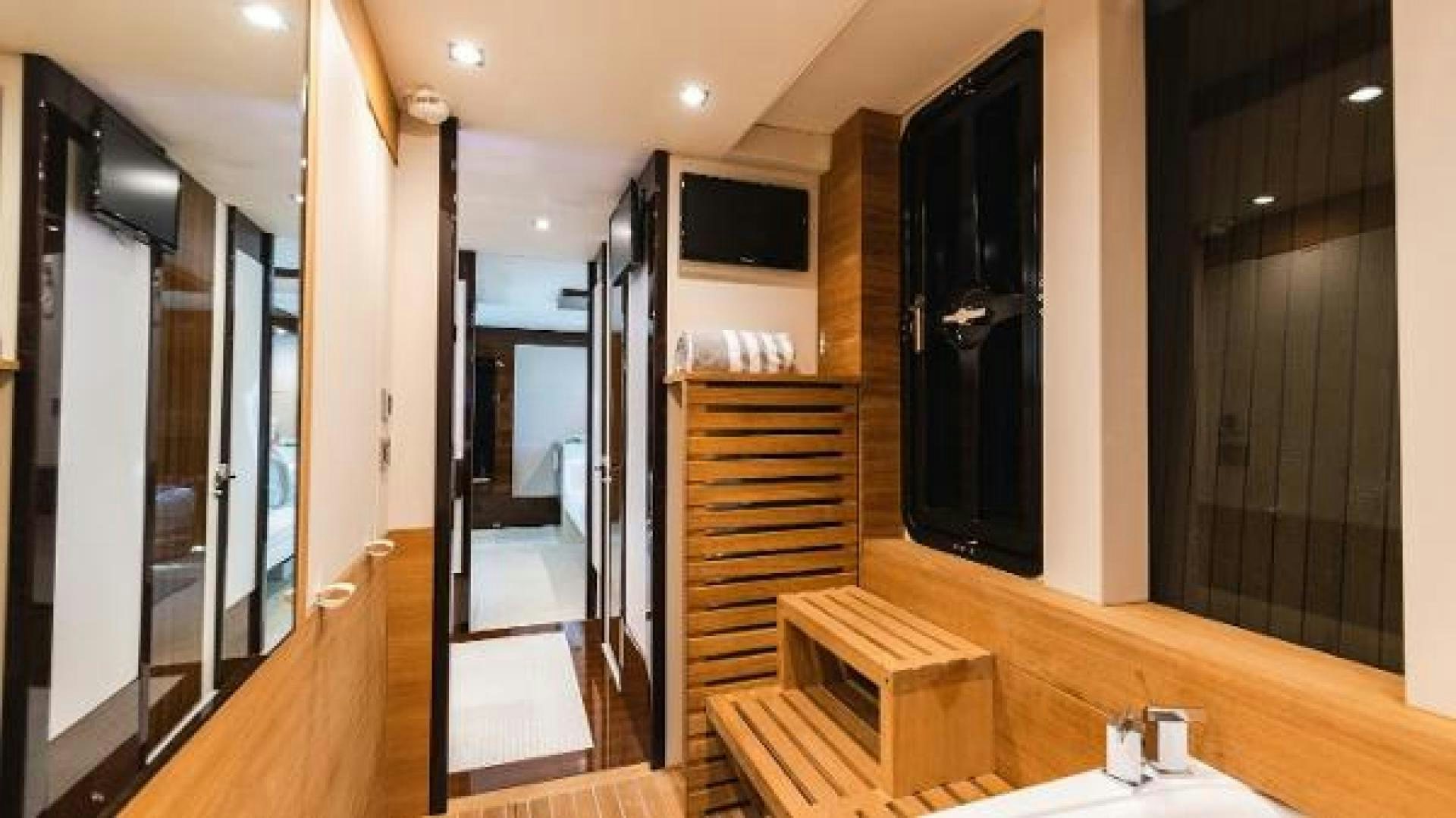 a room with a wood floor and a tv on the wall aboard Z Yacht for Sale
