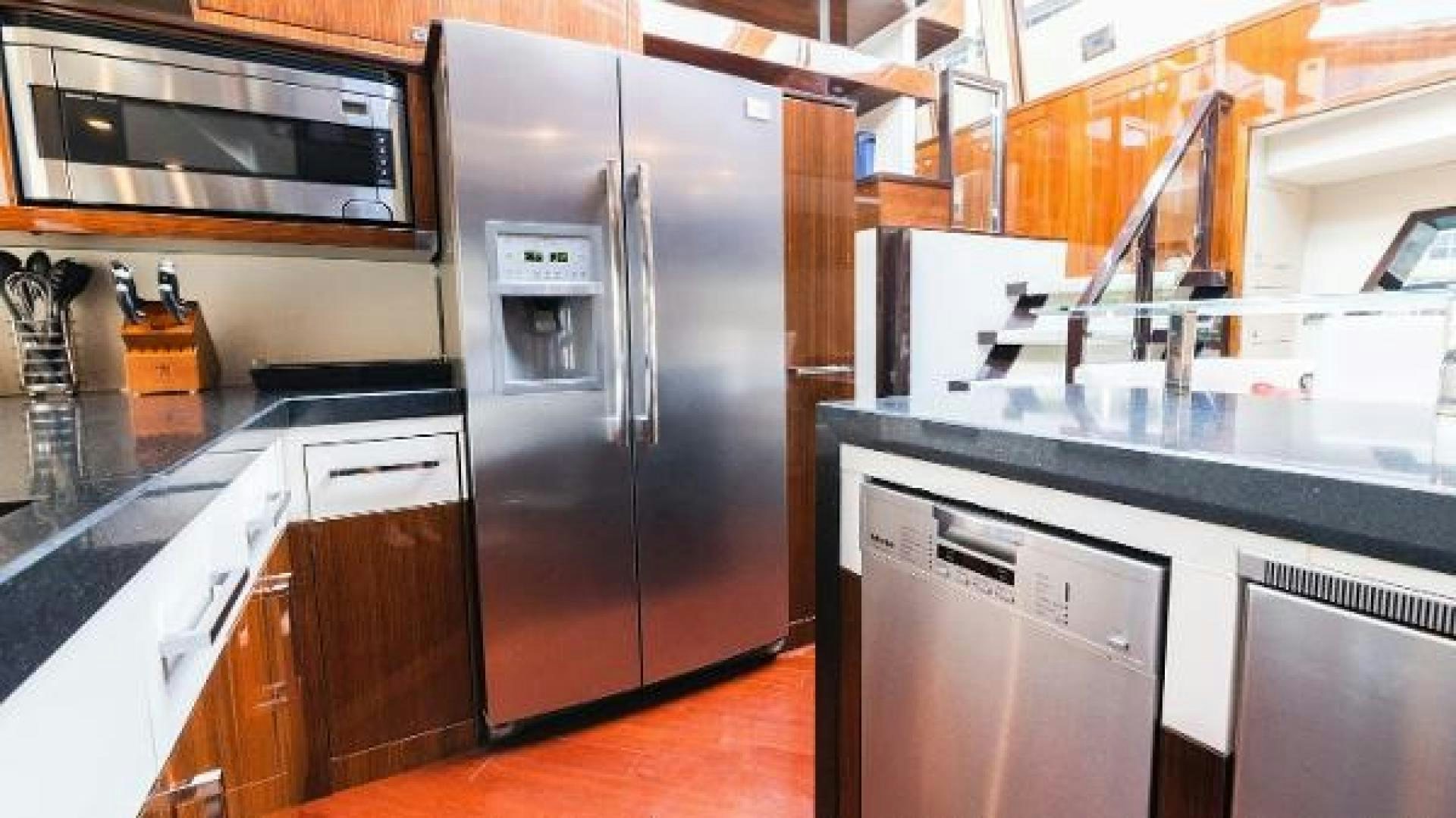 a kitchen with stainless steel appliances aboard Z Yacht for Sale
