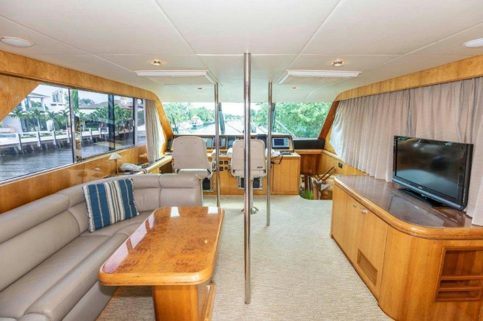 a living room with a tv and a table aboard BELISARIUS Yacht for Sale