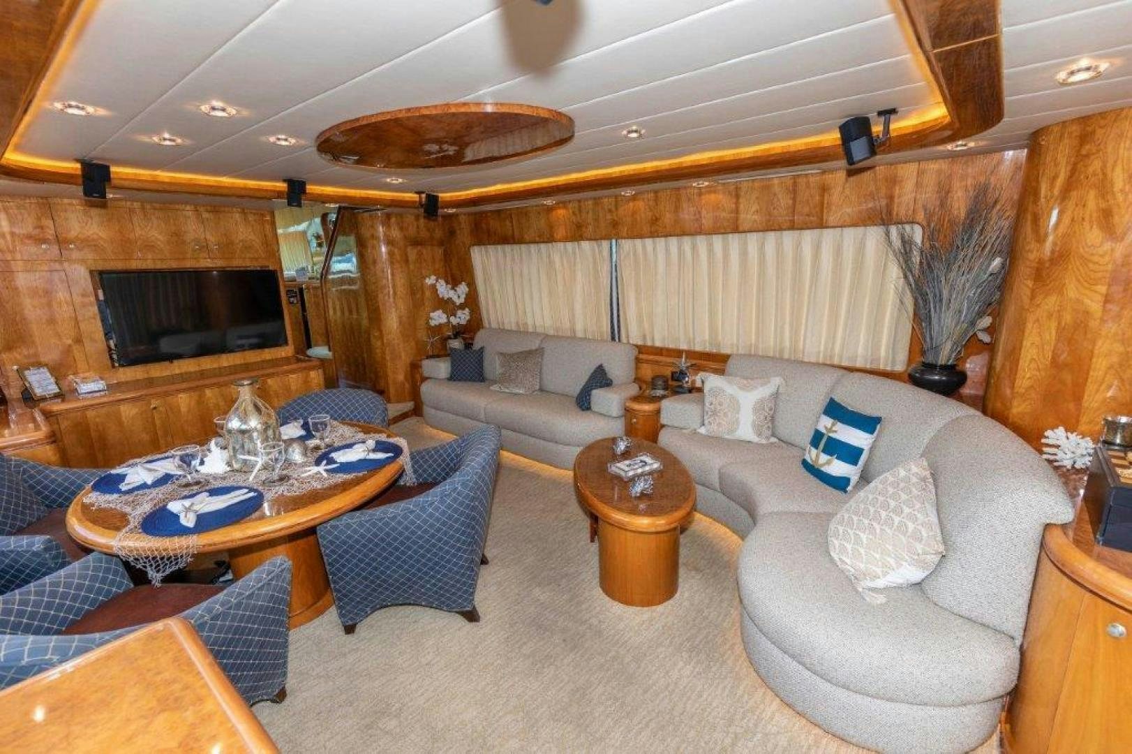 a living room with a large sofa and a fireplace aboard BELISARIUS Yacht for Sale