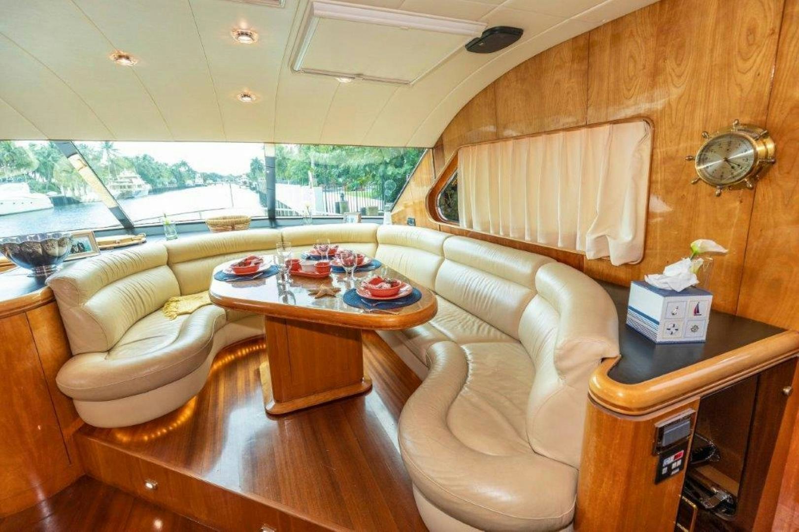 a living room with a table and chairs aboard BELISARIUS Yacht for Sale