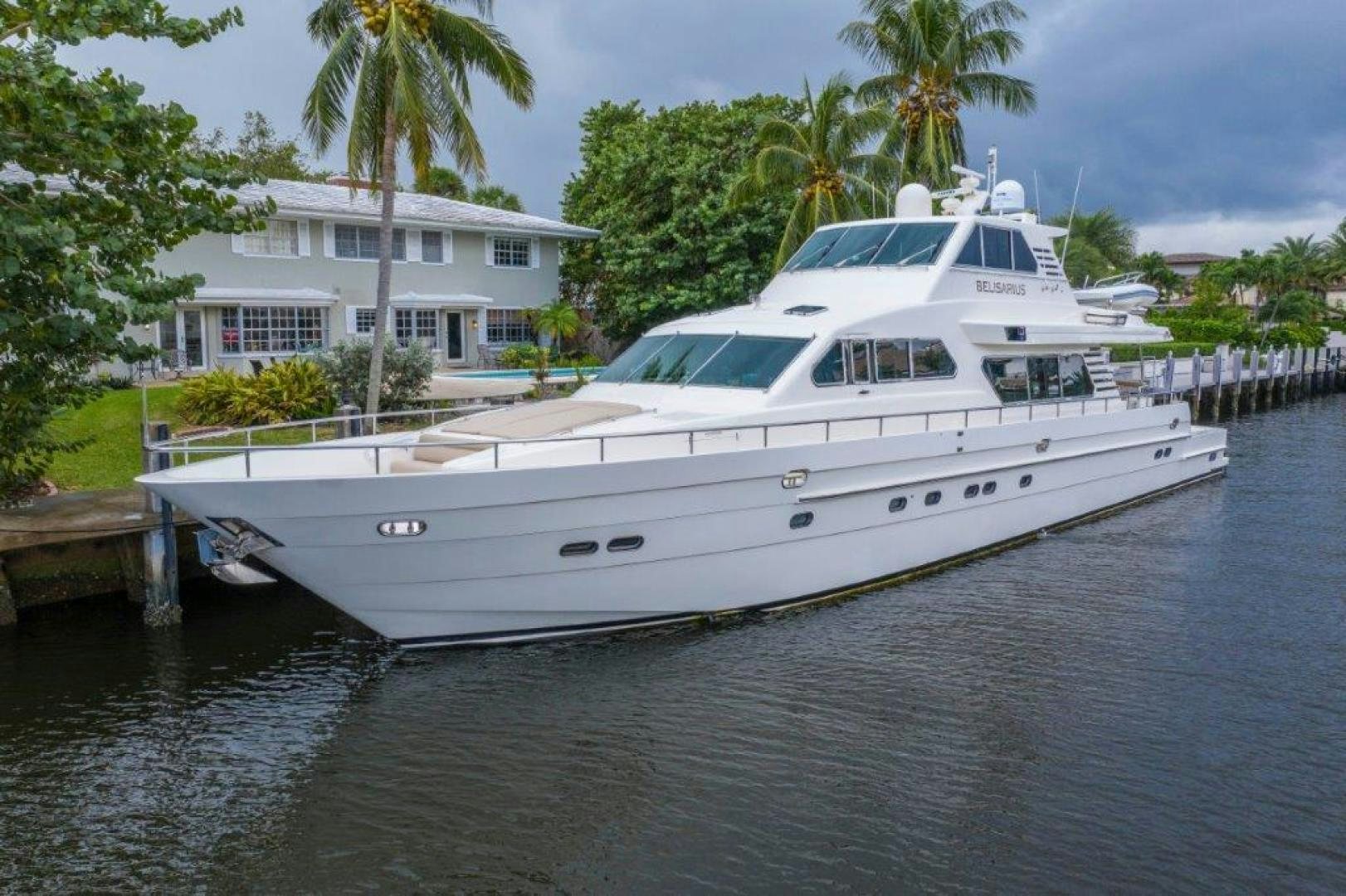 a white boat docked at a pier aboard BELISARIUS Yacht for Sale