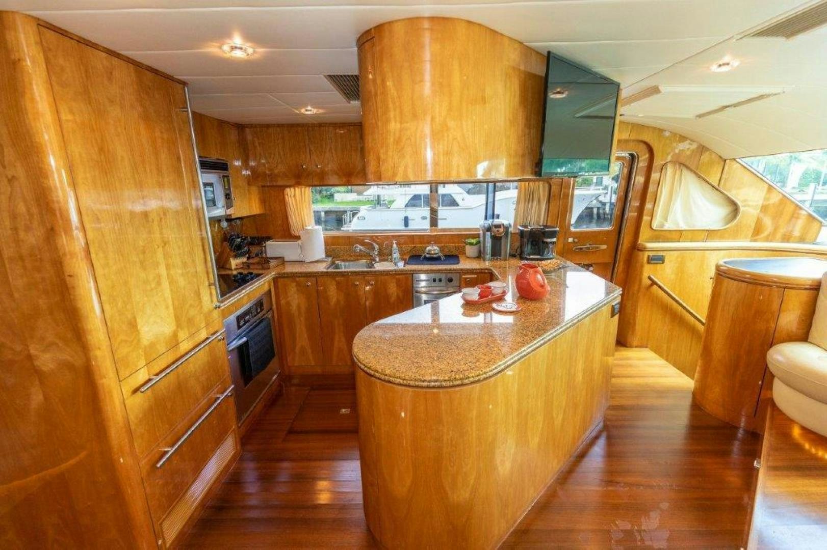 a kitchen with wooden cabinets aboard BELISARIUS Yacht for Sale