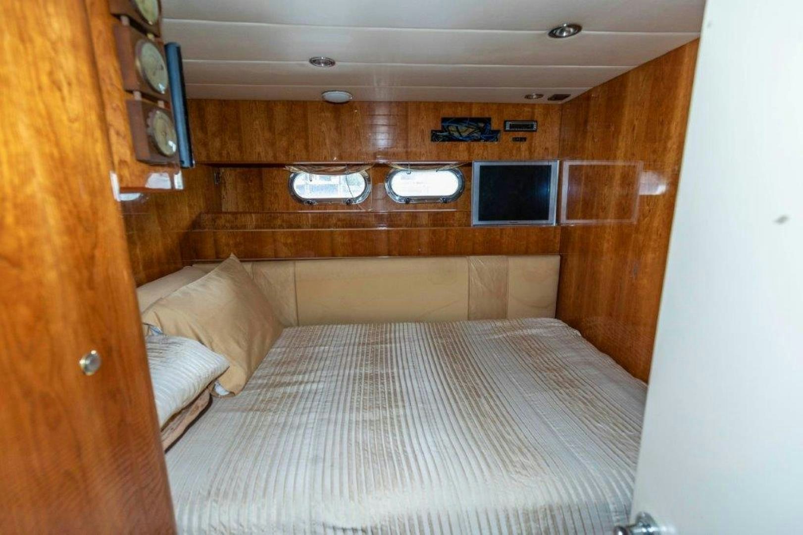 a bed with a wooden headboard aboard BELISARIUS Yacht for Sale