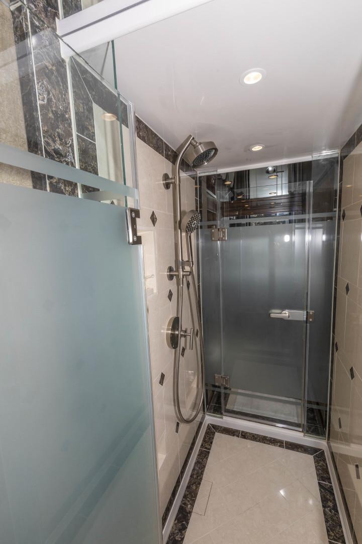 a bathroom with a glass shower aboard BELLA DONA DI Yacht for Sale