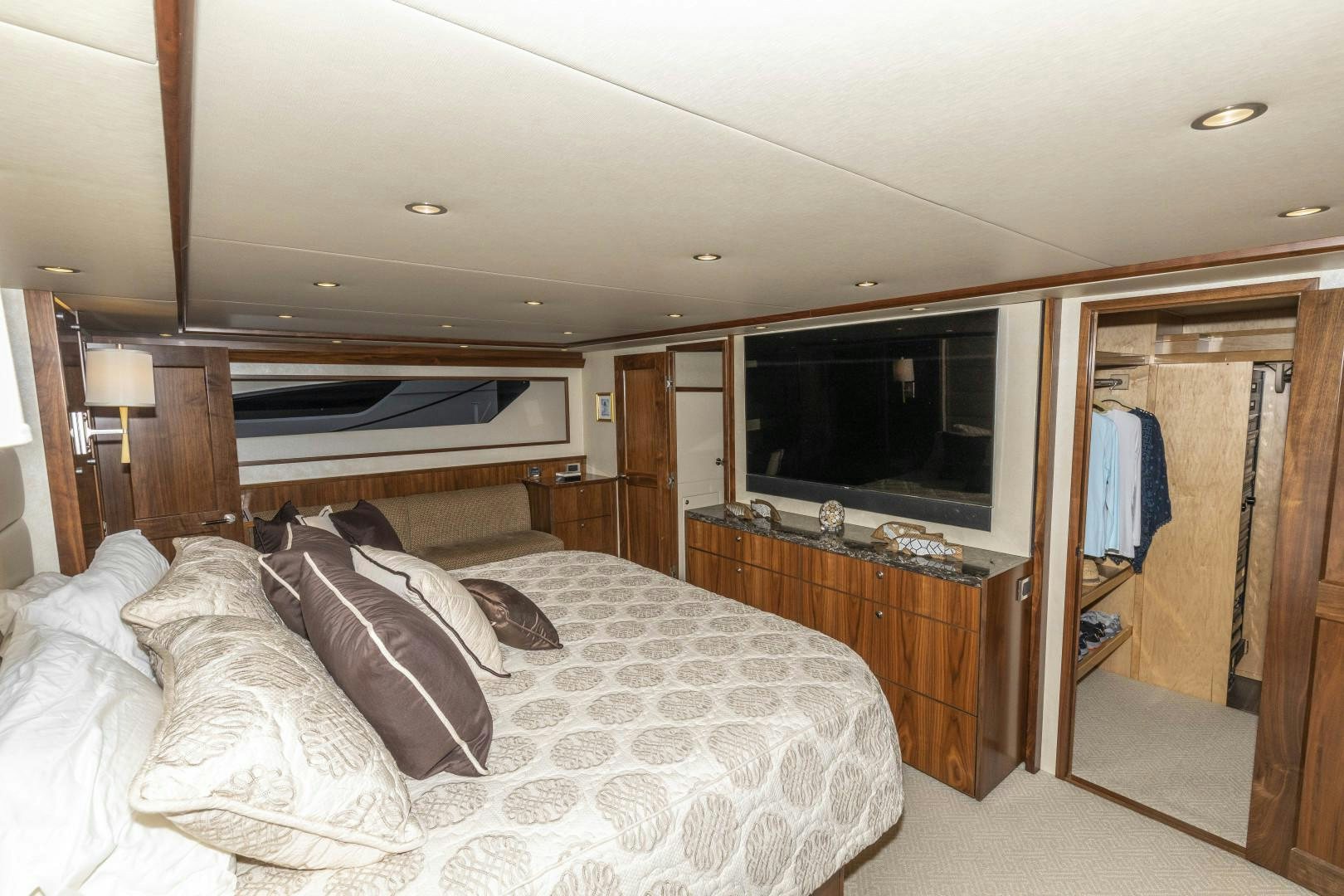 a bedroom with a bed and a television aboard BELLA DONA DI Yacht for Sale
