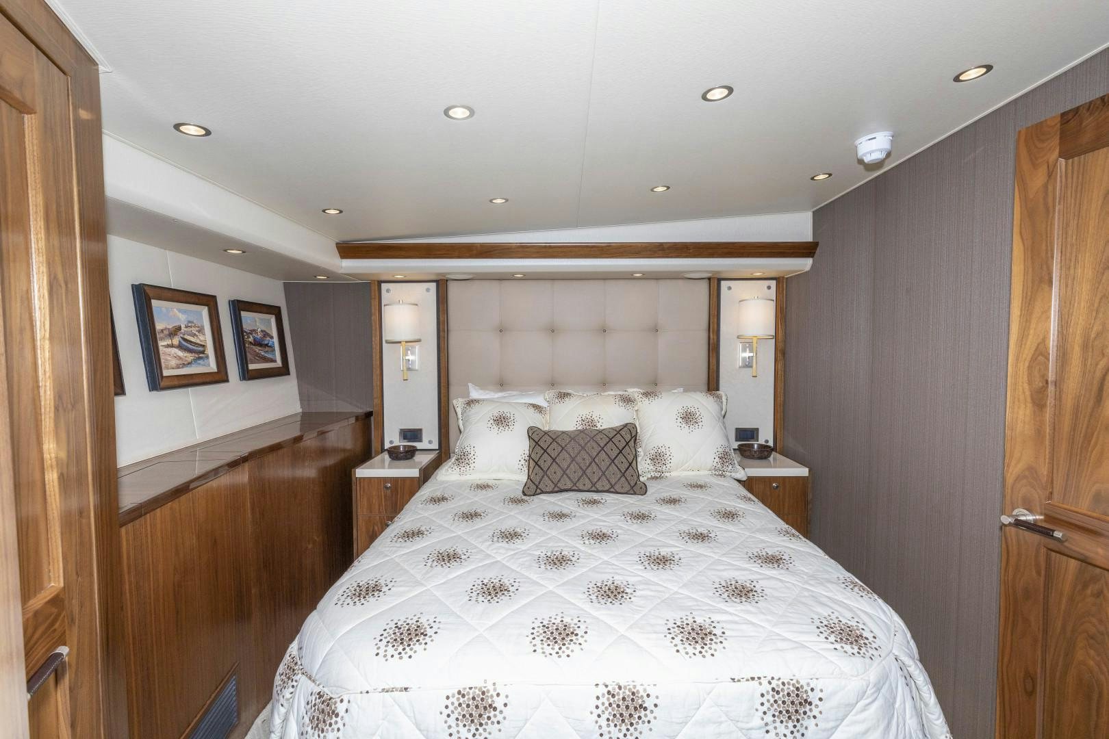 a bedroom with a bed and a wood door aboard BELLA DONA DI Yacht for Sale