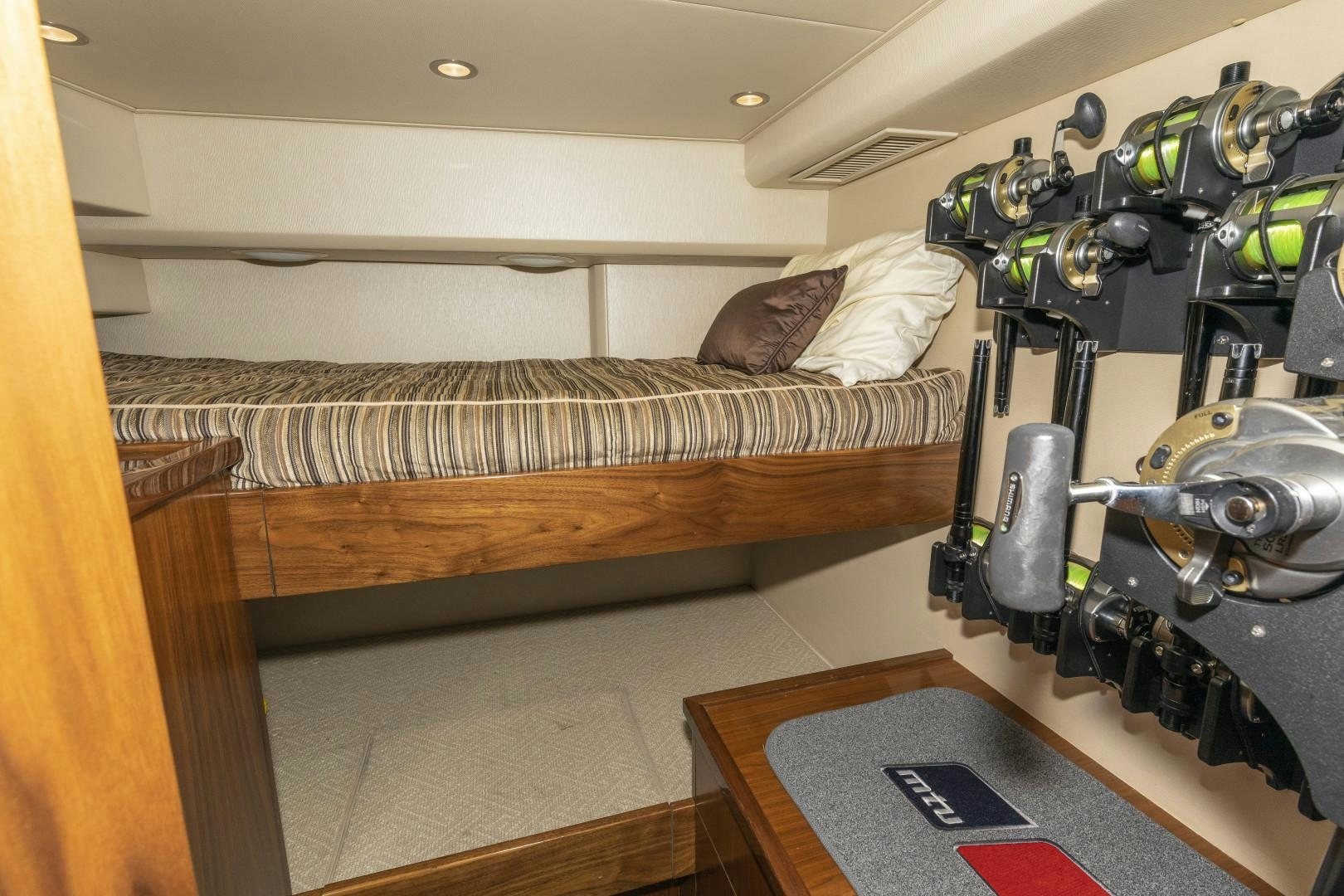 a room with a bed and a bike aboard BELLA DONA DI Yacht for Sale