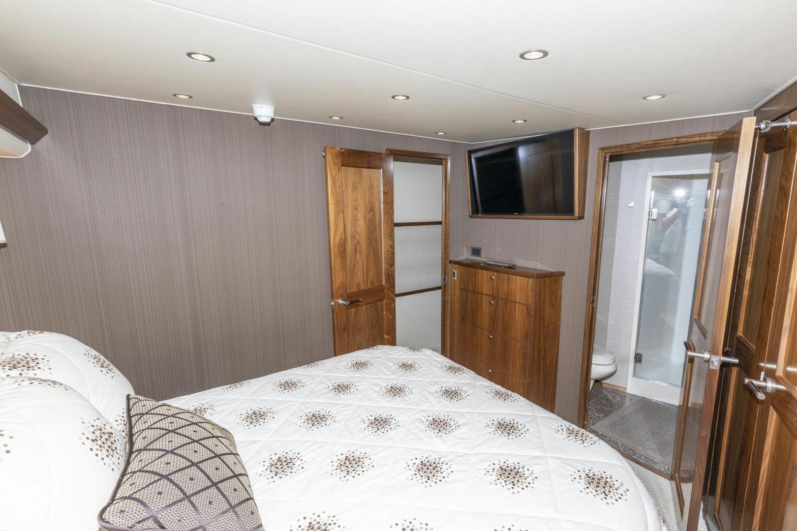 a bedroom with a bed and a television aboard BELLA DONA DI Yacht for Sale