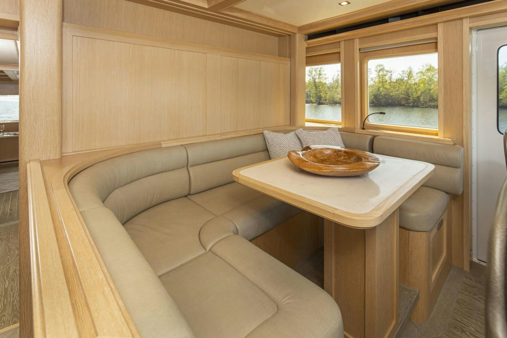 a table with a plate of food on it aboard PARAGON COCKPIT Yacht for Sale