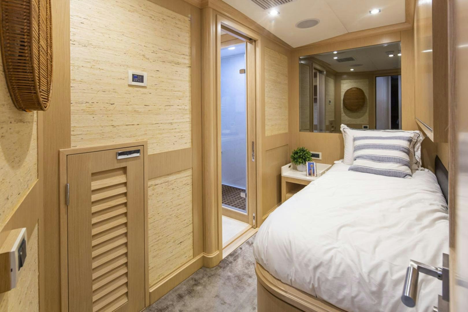 a bedroom with a bed and a mirror aboard PARAGON COCKPIT Yacht for Sale