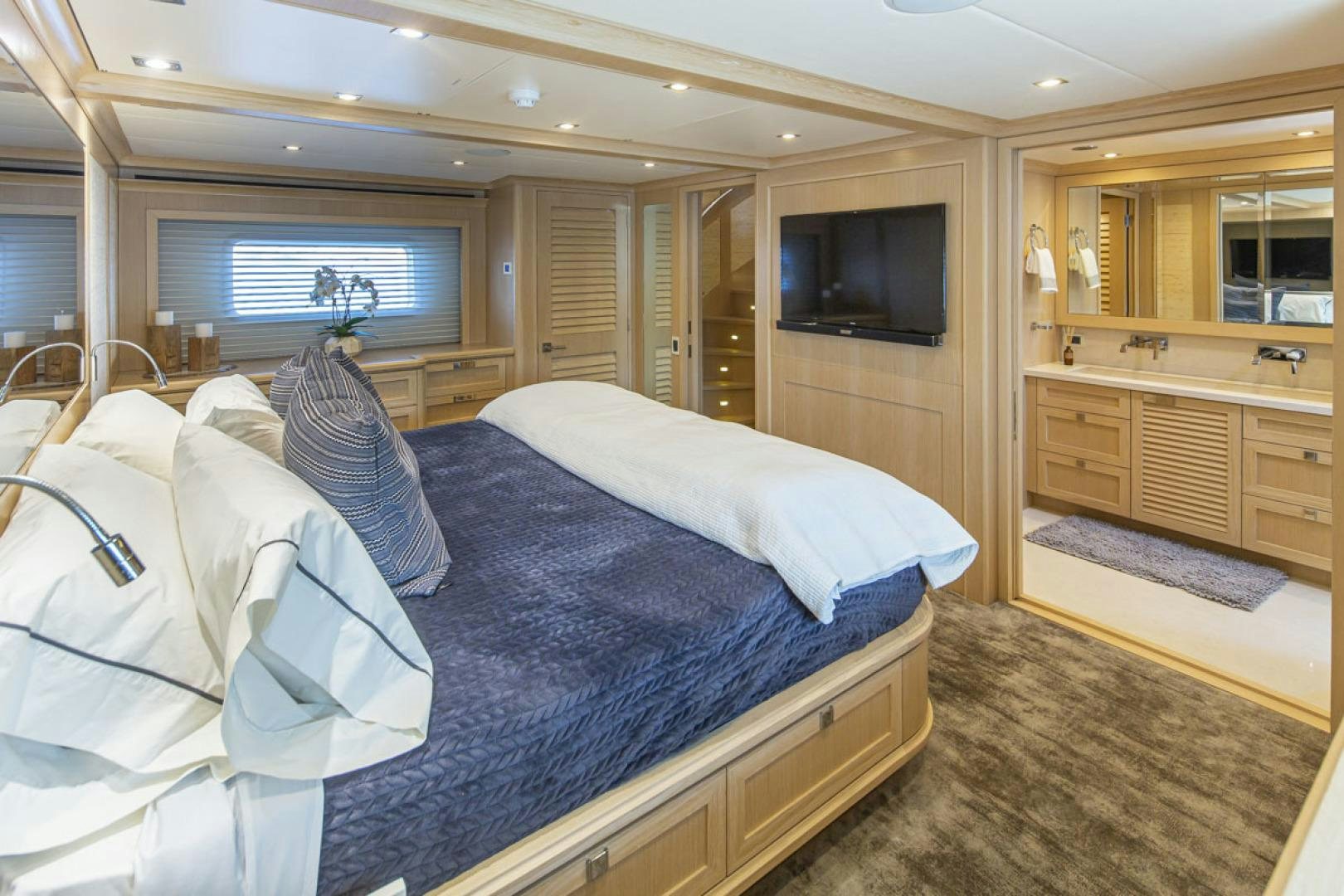 a bedroom with a bed and a television aboard PARAGON COCKPIT Yacht for Sale